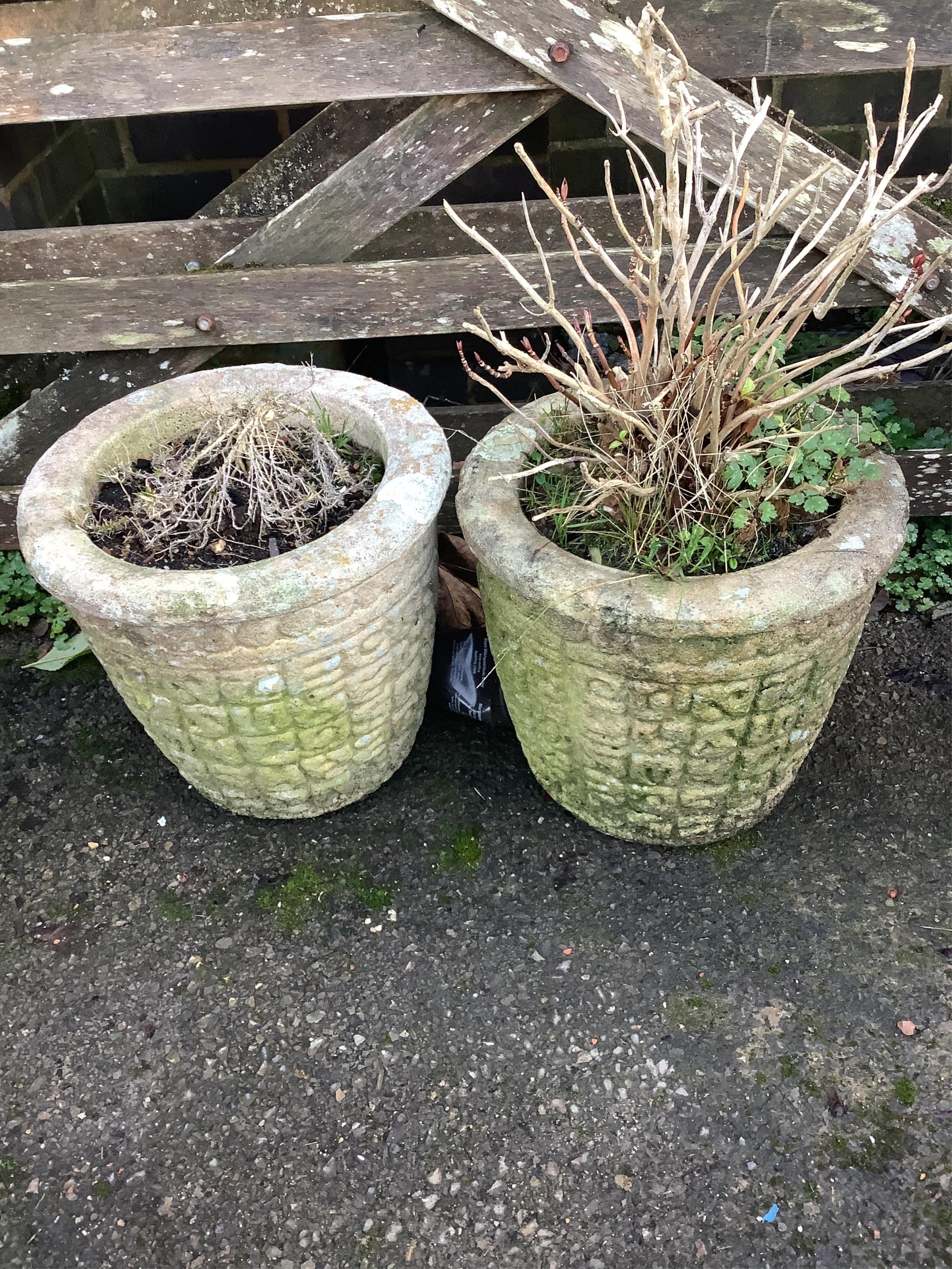 A pair of reconstituted stone patterned garden planters, height 30cm. Condition - fair